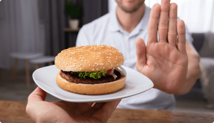 Man with burger and hand