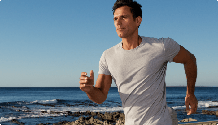Male running along beach